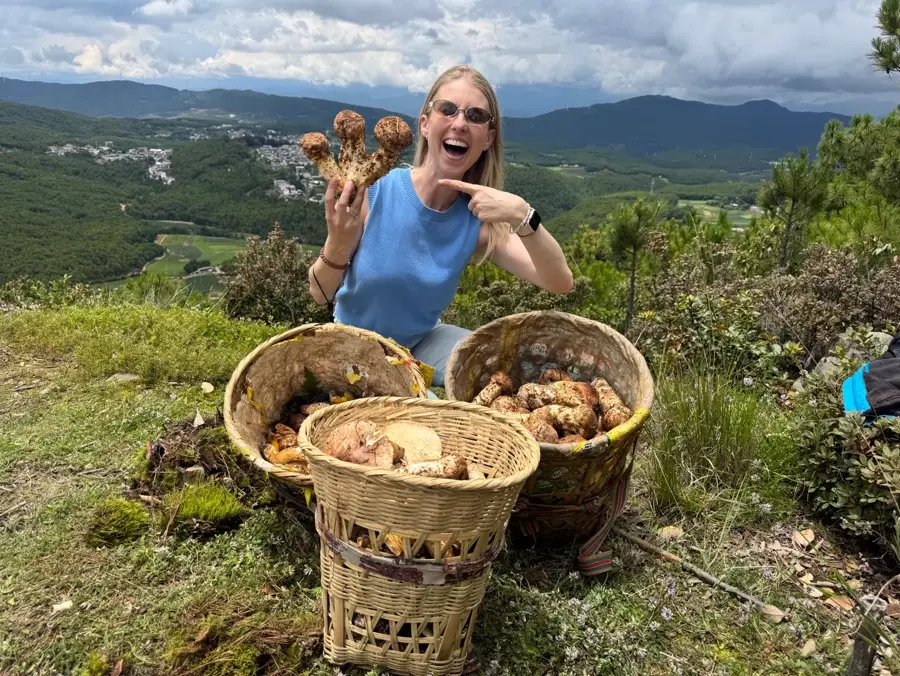 Amy with baskets of wild mushrooms in Yunnan