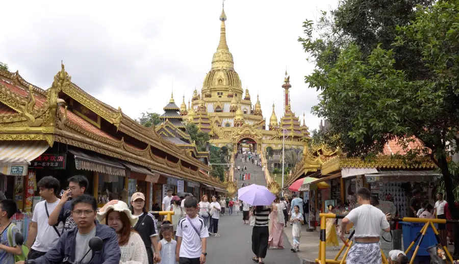 Golden pagoda and market street in Yunnan