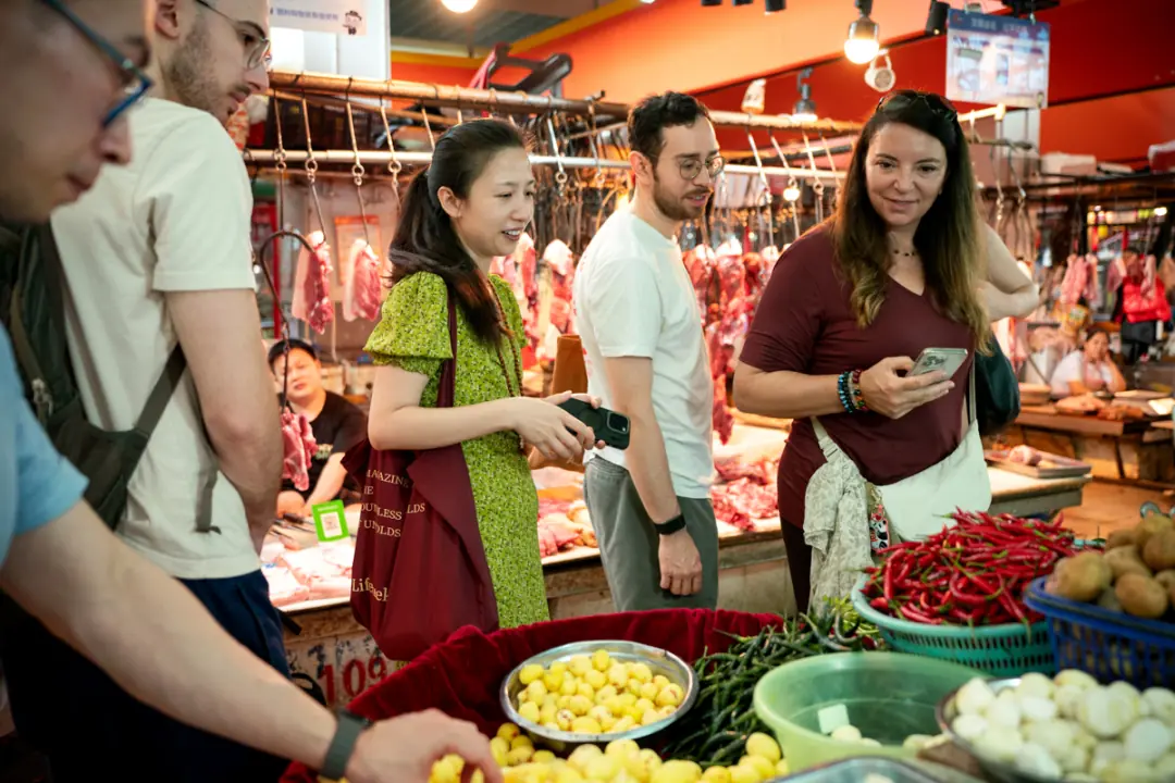 Guests browsing a Sichuan wet market