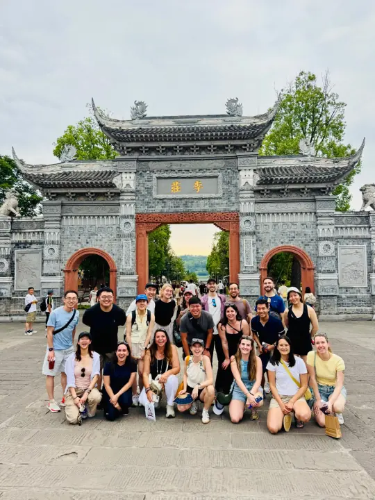 Southwest tour group photo in front of a historic Chinese gate