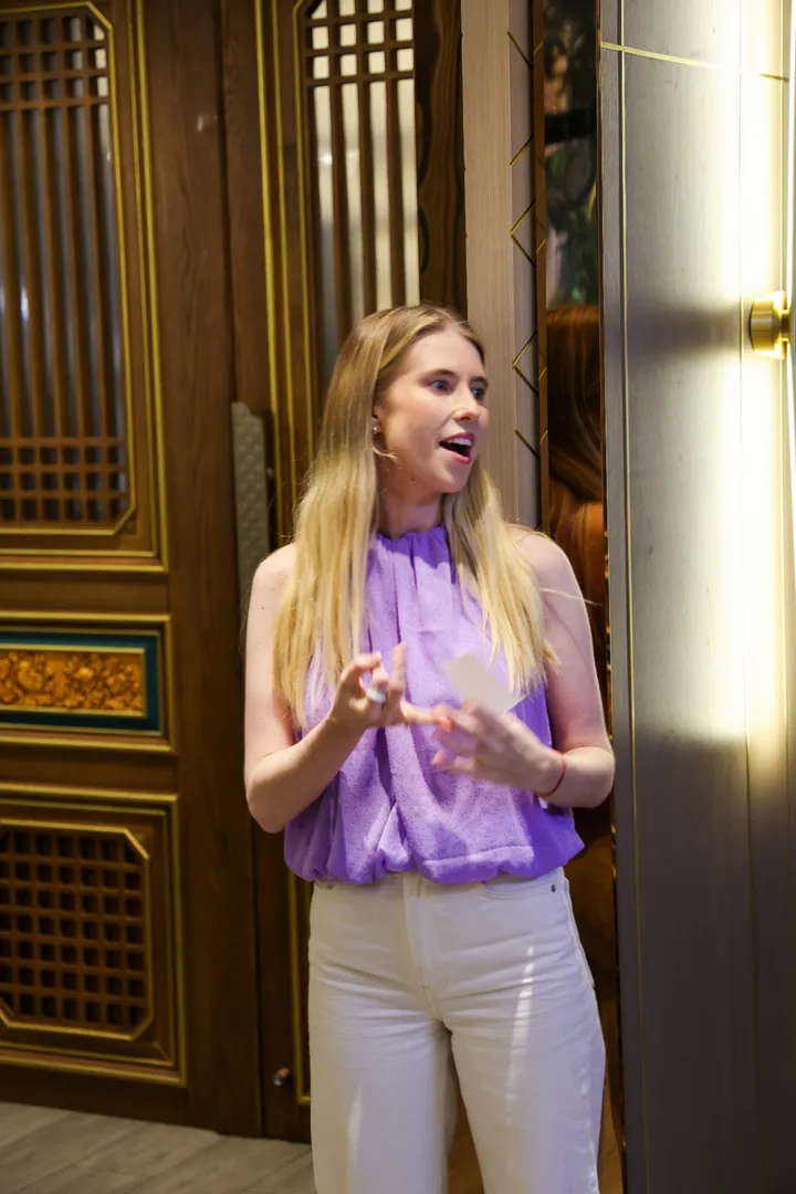Host welcoming guests at a private dining room in Chengdu