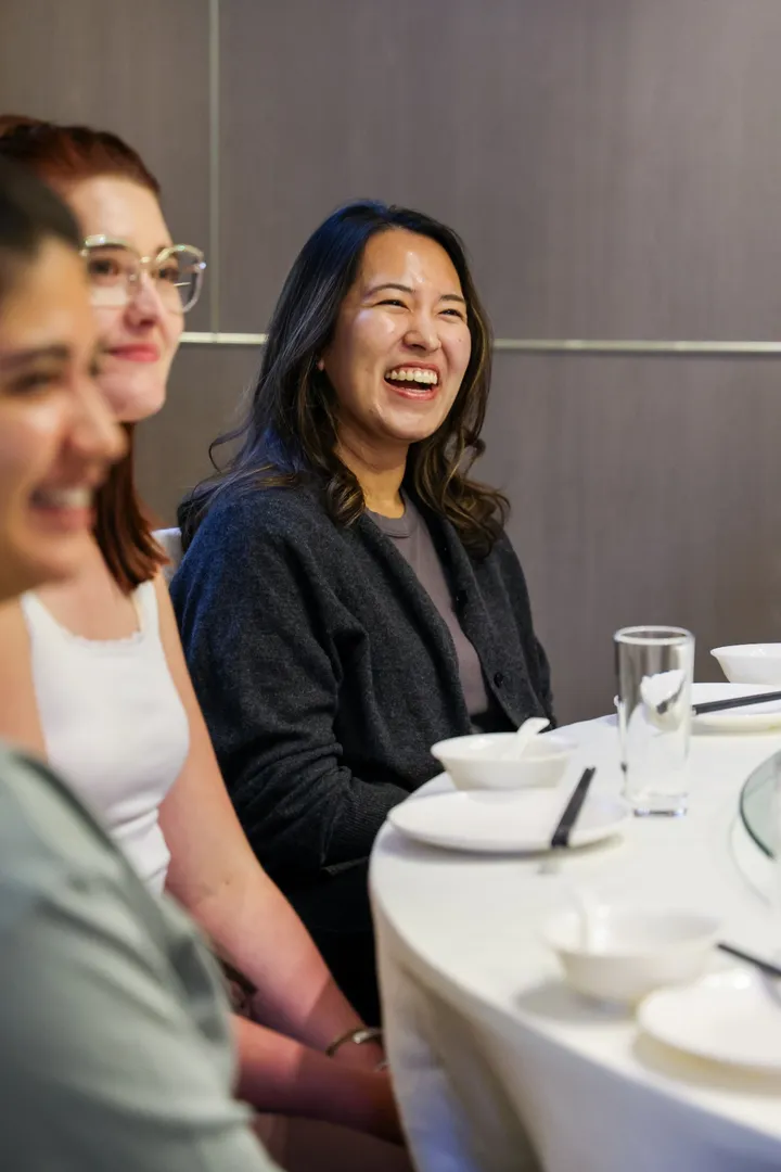 Guests laughing around a Cantonese banquet table