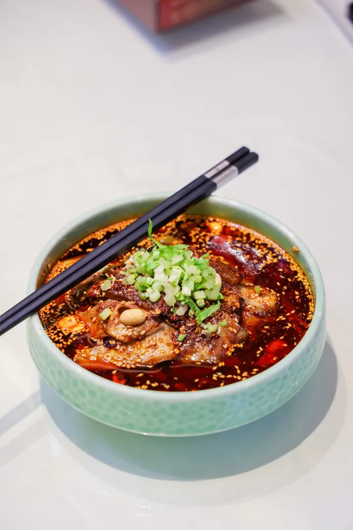 Sichuan poached beef in chili oil with sesame and scallions