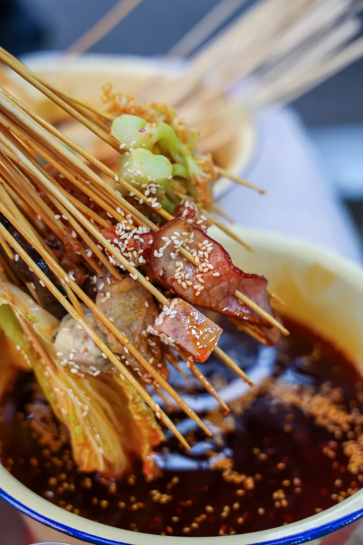 Sichuan street-style skewers lifted from a chili oil pot